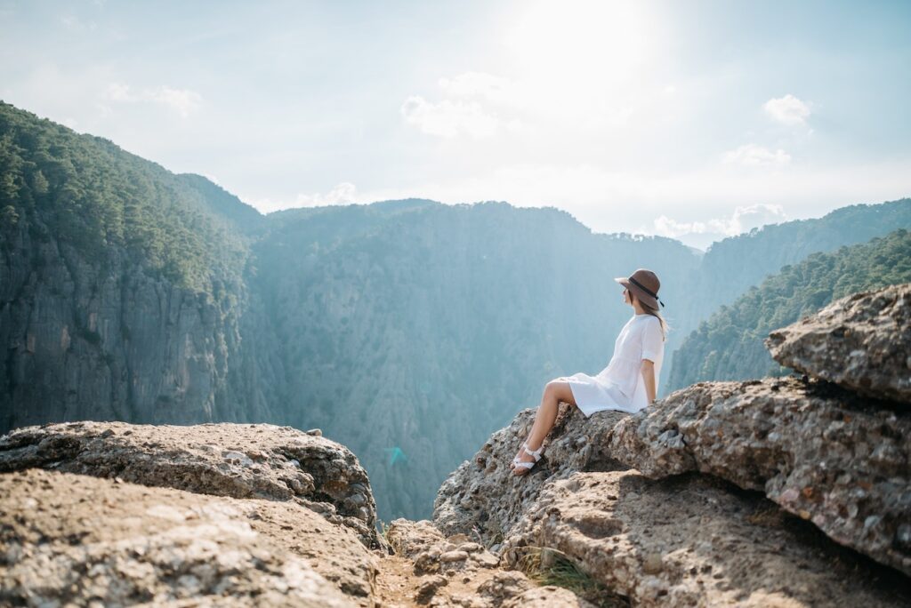 woman standing at the edge of a cliff